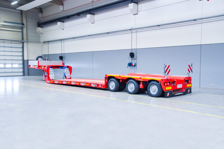 A lowbed trailer with three pendle-axles and outer beams from Faymonville